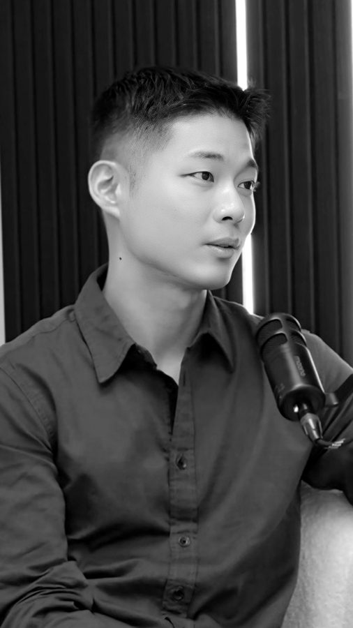 Founder speaking into a podcast microphone.