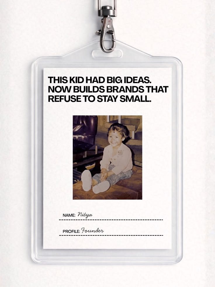 A lanyard ID badge with a childhood photo, reading “This kid had big ideas. Now builds brands that refuse to stay small.”